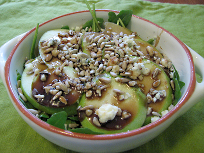 Arugula, granny smith apples, blue cheese crumbles, pine nuts, and dressing (three parts honey to two parts balsamic). This was wonderfully sweet and crunchy.